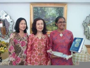 Cik Siti Farishah receiving her bursary award and a copy of On The Bench