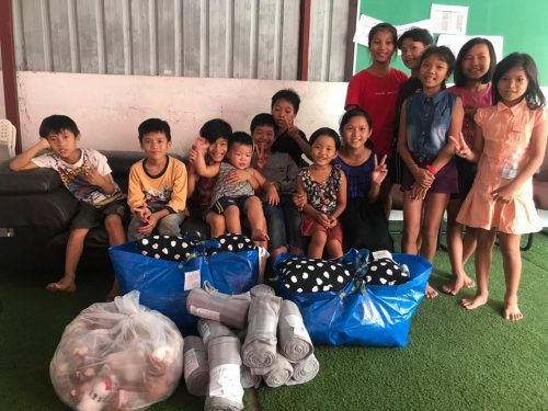 Underprivileged children receiving blankets & soft animals as gifts from Friends of the Yayasan (FotY) - a tiny act of kindness but which makes a difference towards ensuring a comfortable night's sleep